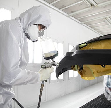 Collision Center Technician Painting a Vehicle | Valley Hi Toyota in Victorville CA