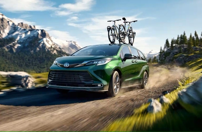 Green 2023 Toyota Sienna with Bikes on Roof Rack